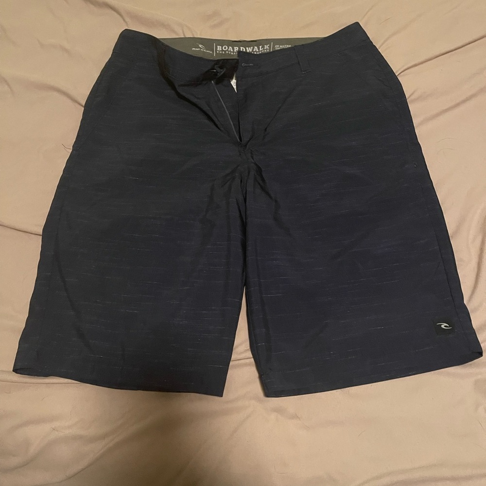 Rip curl size 30 navy blue with the late stripe pattern